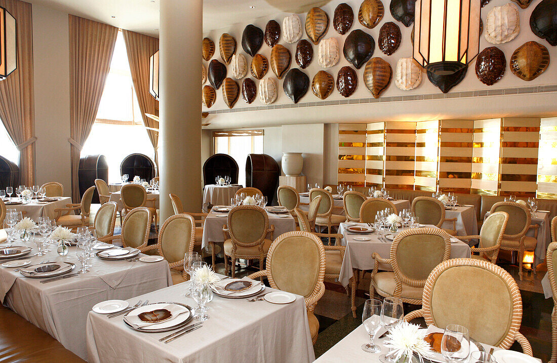 Tables are laid at  the deserted La Mer restaurant, Tides Hotel, Ocean Drive, South Beach, Miami Beach, Florida, USA