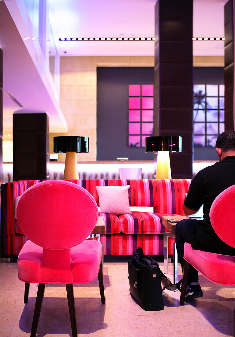 A man at the lobby of the Gaansevoort South Hotel, South Beach, Miami Beach, Florida, USA