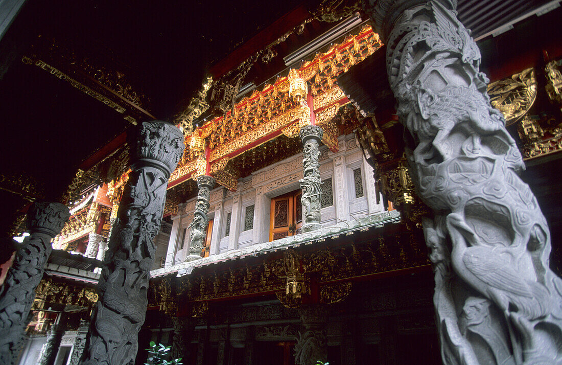 Artful decorated columns in front of the Tsushih temple in the city of Sanshia, Taiwan, Asia