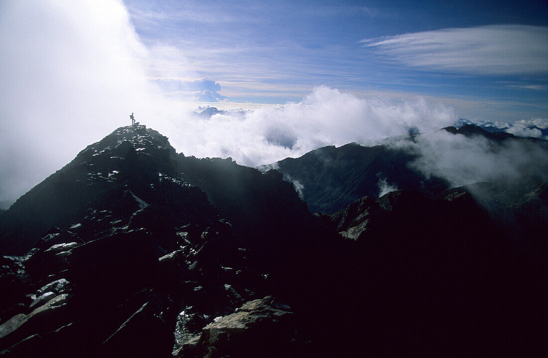 On the main peak of Yushan mountains in front of white clouds, Yushan National Park, Taiwan, Asia