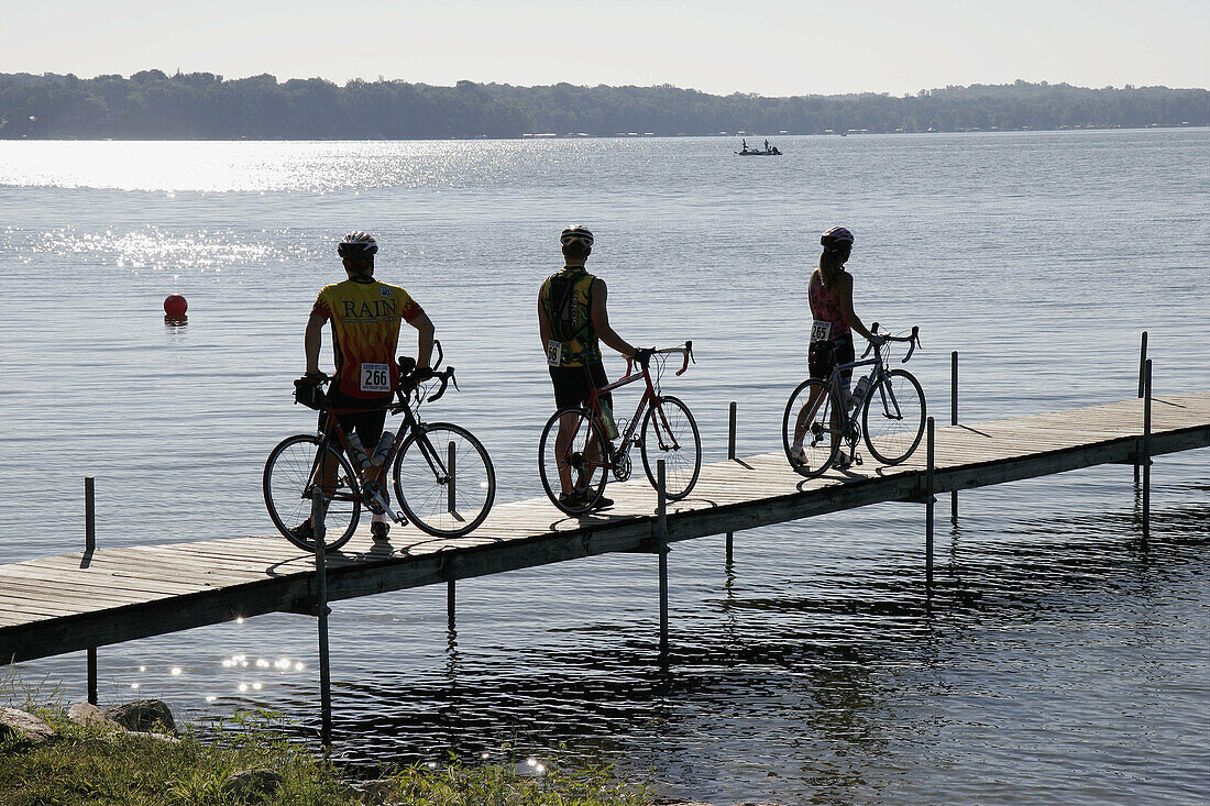 Lake Maxinkuckee, pier, bicycles, bikers. Culver Park. Culver. Indiana. USA.