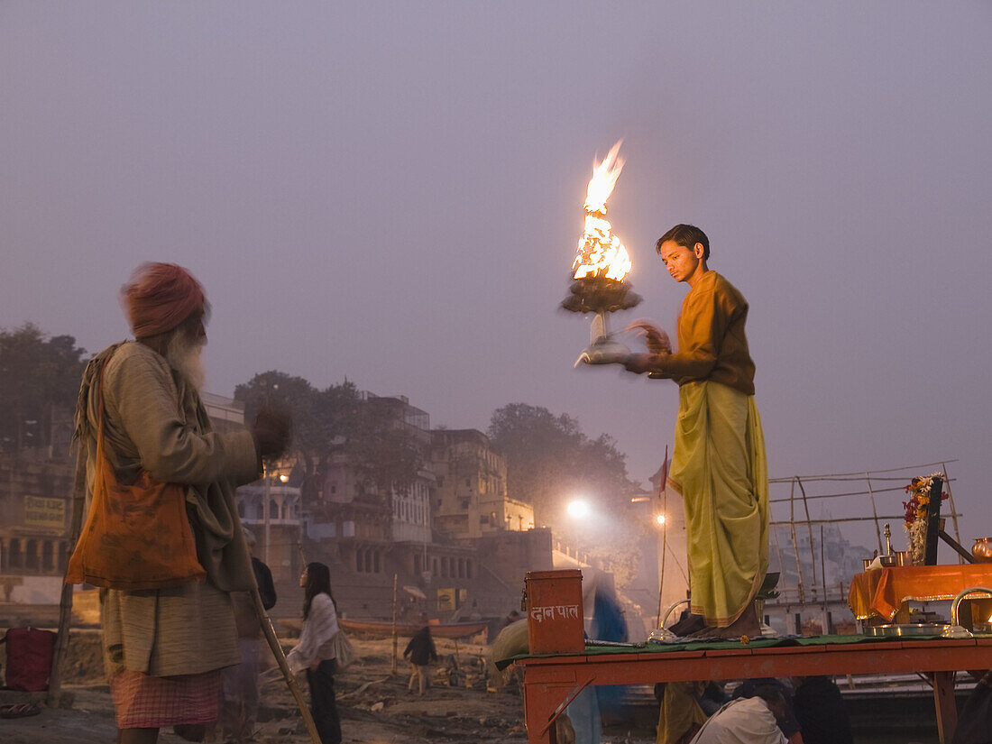 A Hindu priest performs a ritual at dawn on the bank of the holy river Ganges, an important pilgrimge site for Hindu's, in Varanasi, Uttar Pradesh, India