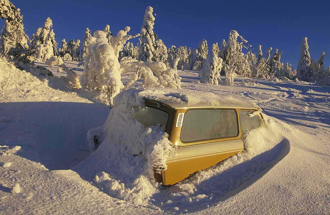 car (Trabant) stranded in the snow, Ore Mountains, Saxony, Germany.