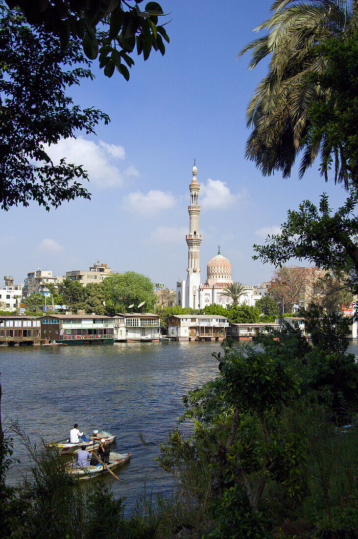 Two rowboats in the Nile River with a mosque in Cairo, Egypt