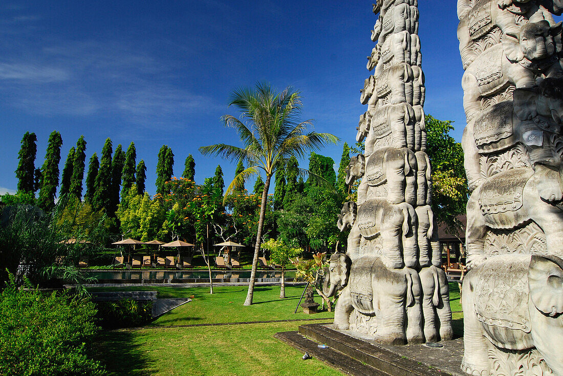 Candi, Temple gate at the garden of the Chedi Club under blue sky, GHM Hotel, Ubud, Indonesia, Asia