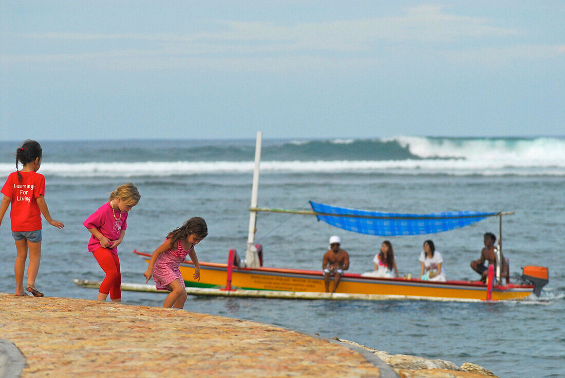 Children and boat on the beach of Sanur, South Bali, Indonesia, Asia