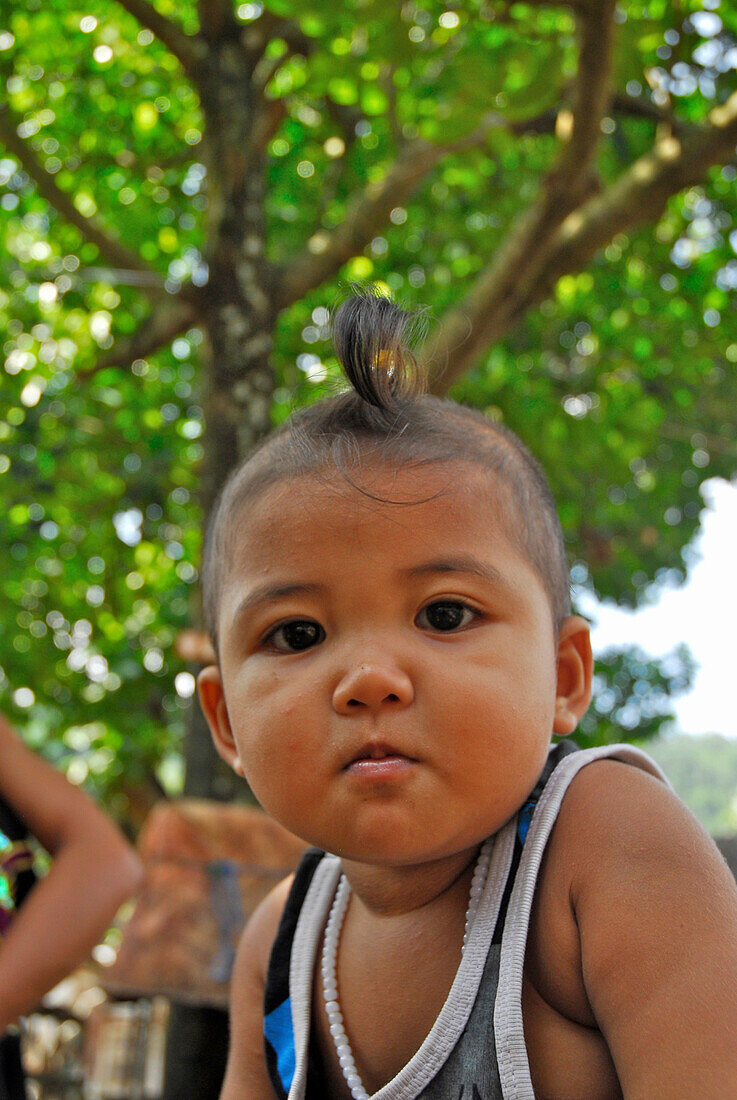Portrait of a child at Tenganan, Bali Aga village, East Bali, Indonesia, Asia