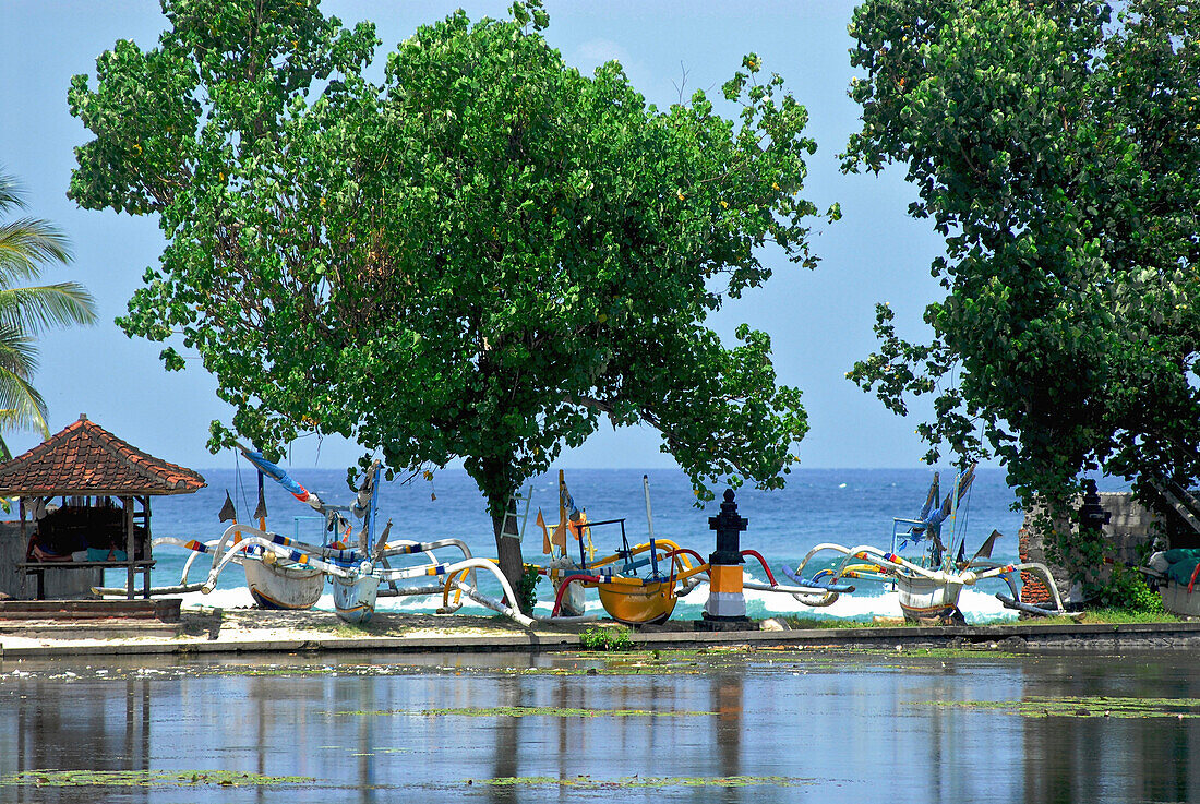 Pond at Candi Dasa with boats on the beach, Candi Dasa, Bali, Indonesia, Asia