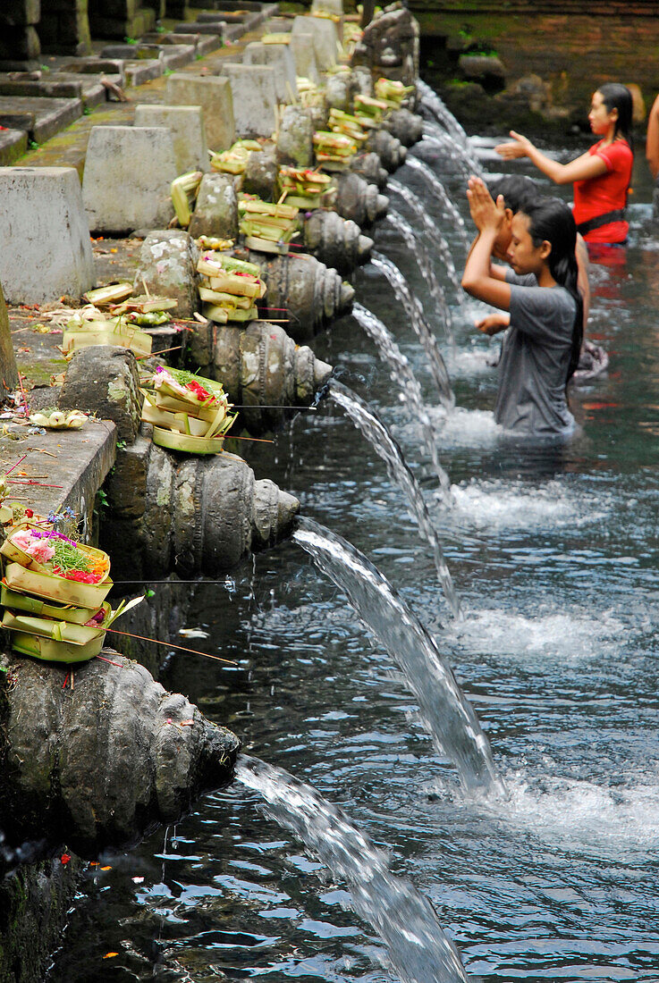 Locals in a water basin at Tirtha Empul temple, Central Bali, Indonesia, Asia