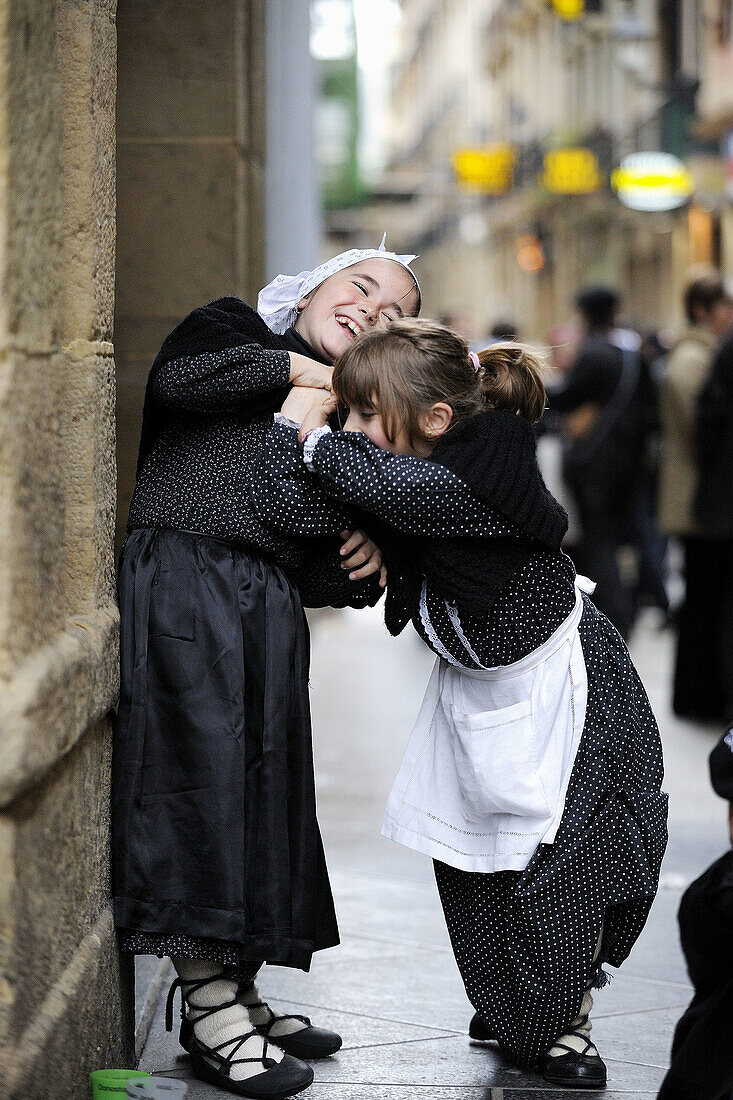 Girls dressed in costumes playing in the streets of San Sebastian, Donostia, Basque country, Spain.