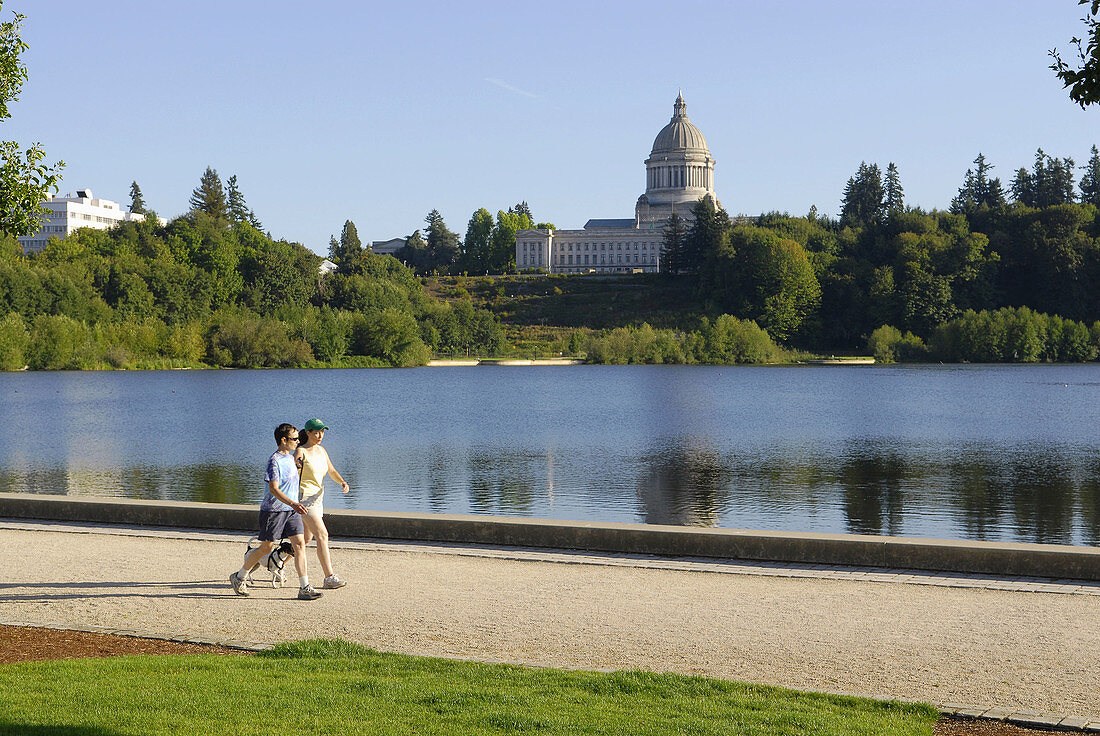 visitors residents walk along Capitol Lake with View of Capitol Building Olympia Washington WA US United States capital legislature legislative laws legal government representatives architects Walter Wilder and Harry White exercise healthy