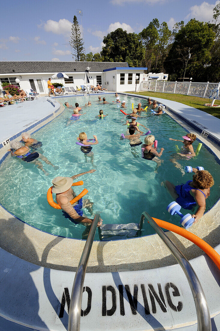 Senior citizens enjoying retirement in a resort swimming pool