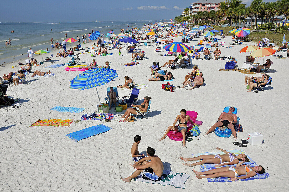 Visitors to Fort Myers Beach Florida enjoy sun and water