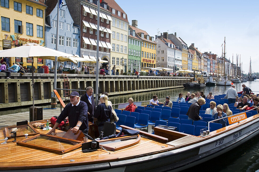 Tourist boat and typical architecture at Nyhavn canal. Copenhagen. Denmark