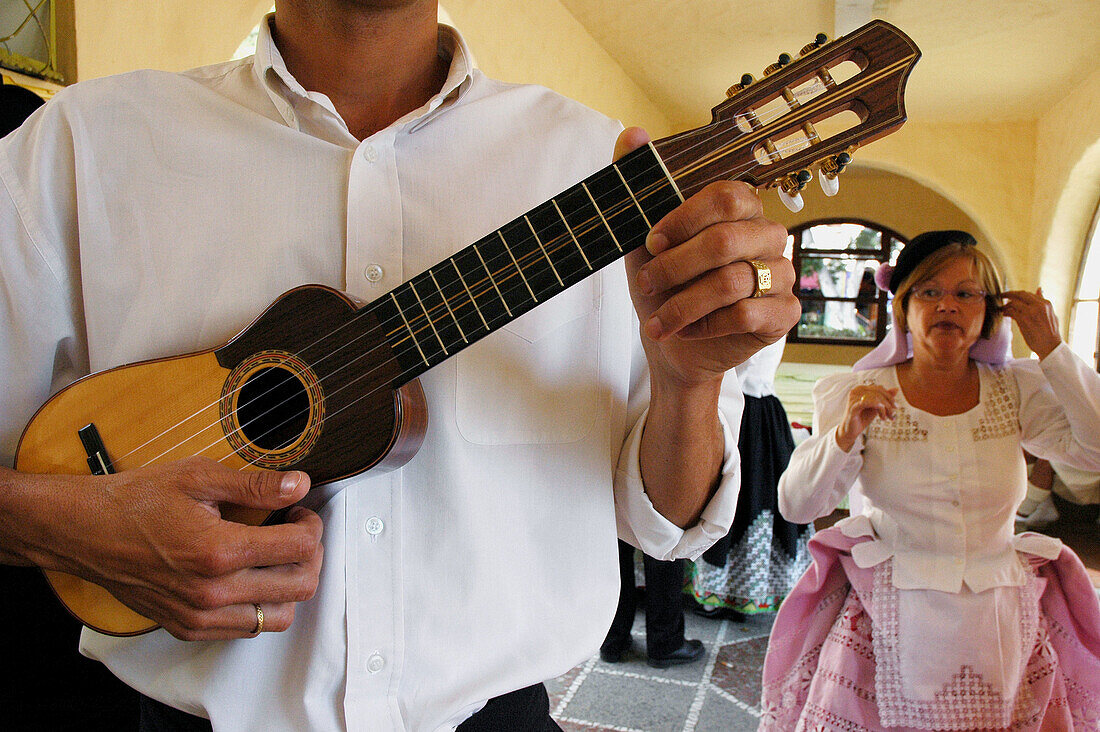 Timple (traditional guitar of the canary islands). Traditional dance, dresses designed by the artist Nestor. Recinto del Pueblo Canario. Las Palmas de Gran Canaria. Grand Canary. Canary Islands. Spain
