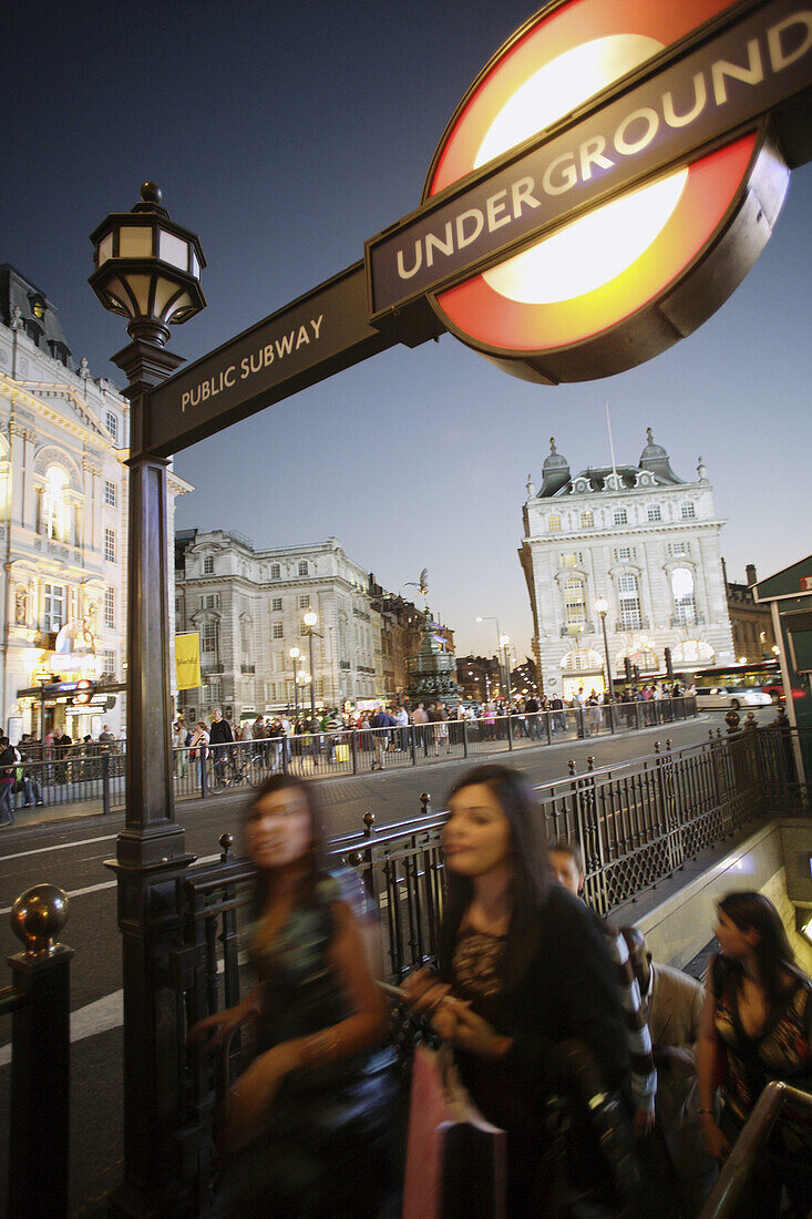 Young cosmopolitan people coming out of the underground or public subway at Piccadilly Circus, London, United Kindom, Europe