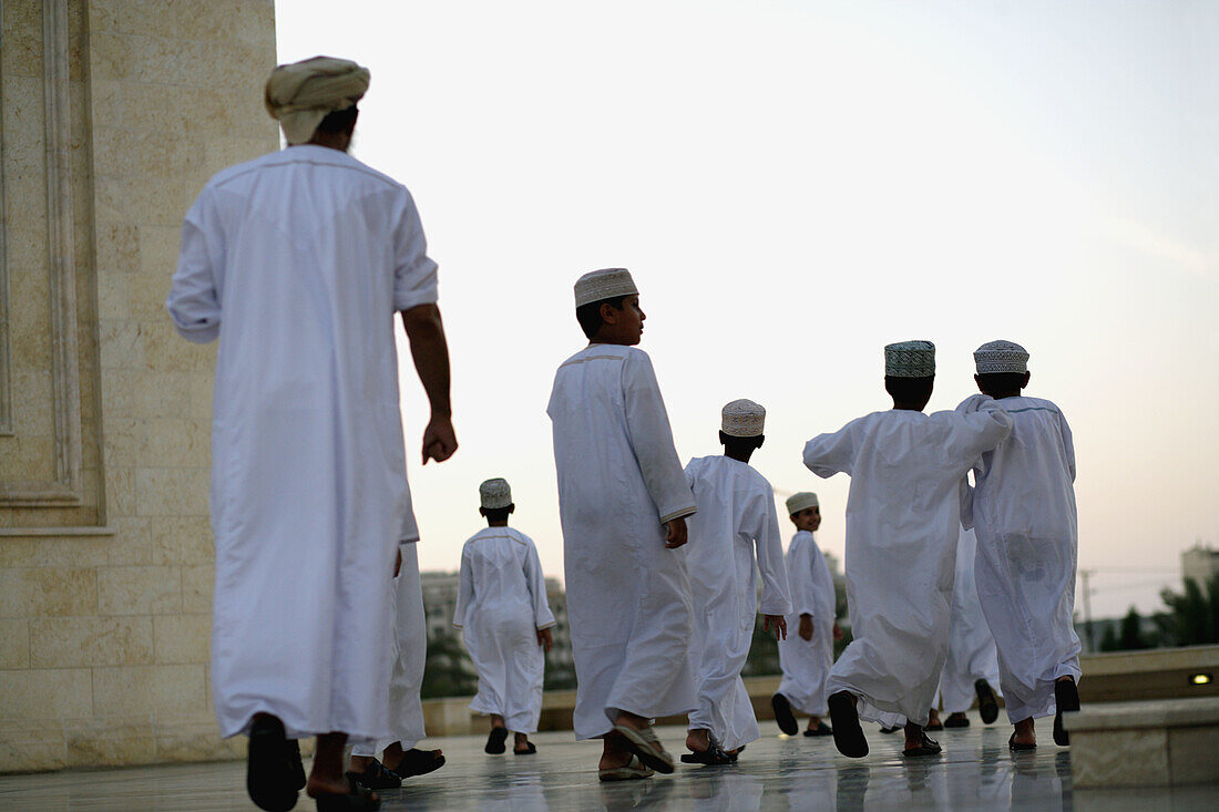 Imam with his young moslem scholars at a mosque in Muscat at dusk just before the evening prayer, Oman, Arabia, Middle East, Asia