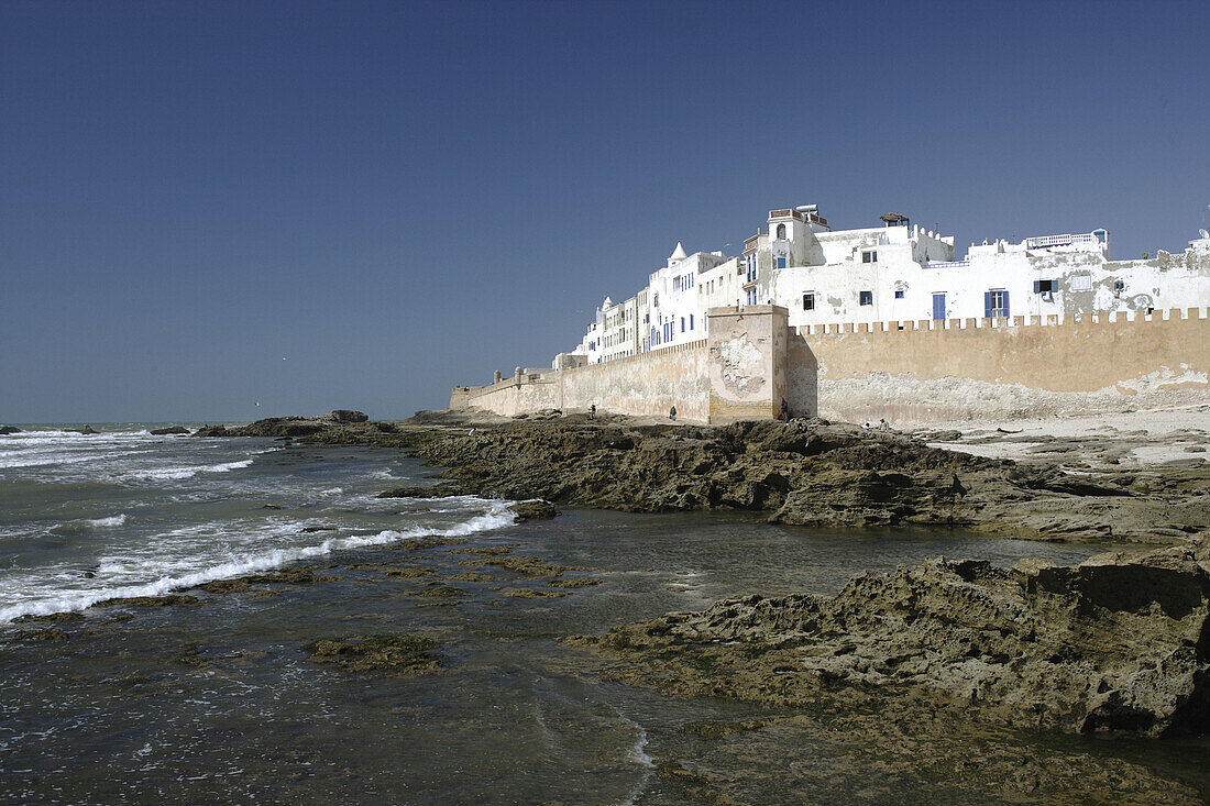 View of the impressive portugese fortification of Essaouira with the surf of the Atlantic Ocean and the white washed buildings and blue doors and window frames - typical for a former judish settlement, Morocco, Maghreb, North Africa