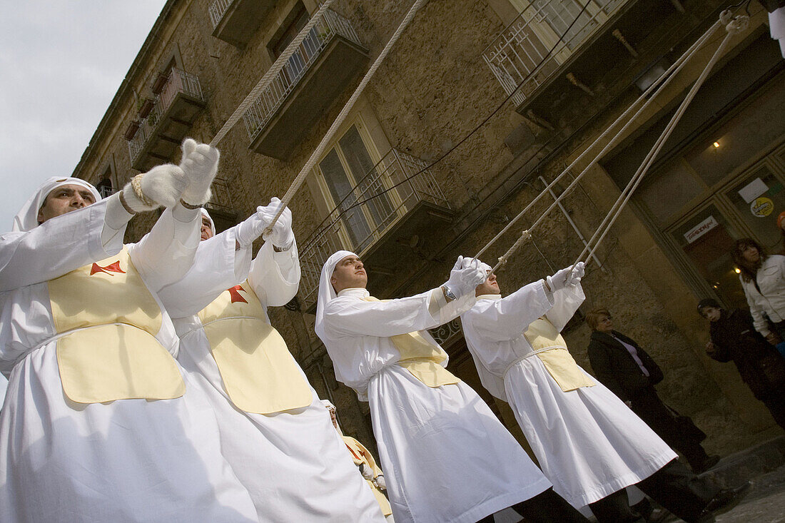 Men dressed in traditional costumes and carrying a Christ coffin during the Easter processions. Enna. Sicily. Italy