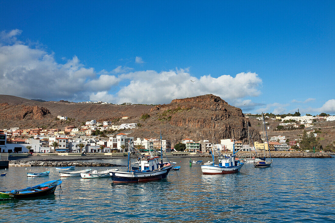 Fishing boats are moored at the harbour of Playa de Santiago, La Gomera, Canary Islands, Spain, Europe