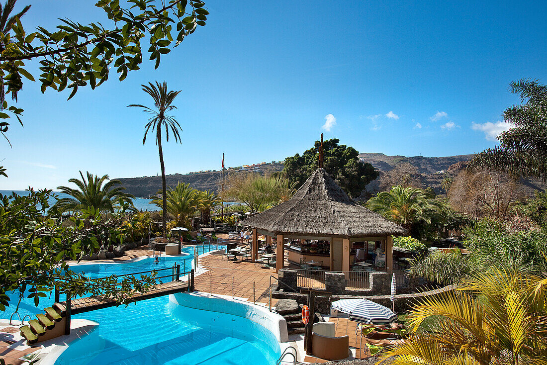 View over the swimming pool of Jardin Tecina Hotel in the sunlight, Playa de Santiago, La Gomera, Canary Islands, Spain, Europe