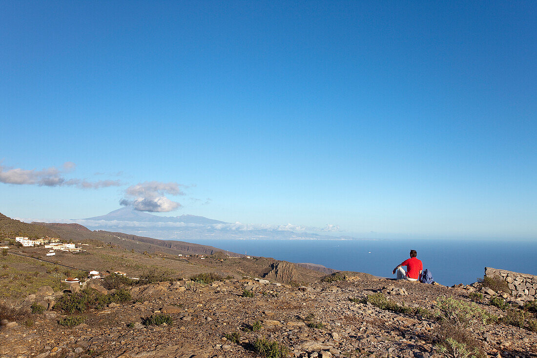 Hiker looking at the view at Teide volcano and at the sea, La Gomera, Canary Islands, Spain, Europe