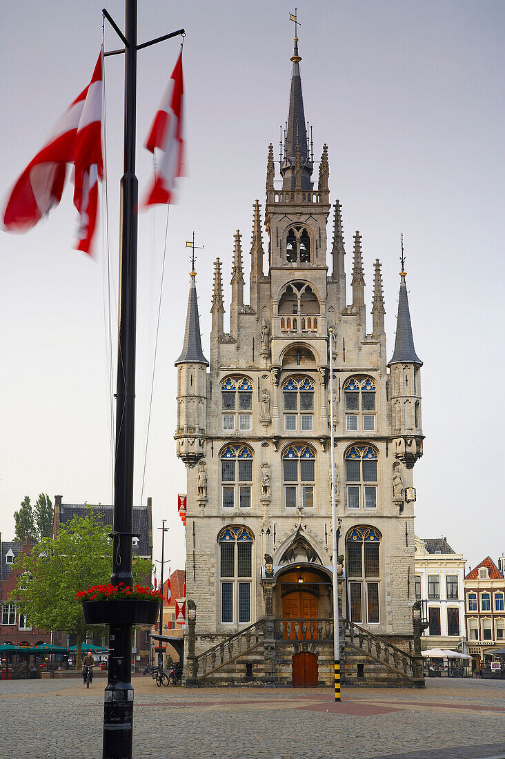 Flags in front of the gothic town hall at the market place at the Old Town, Gouda, Netherlands, Europe