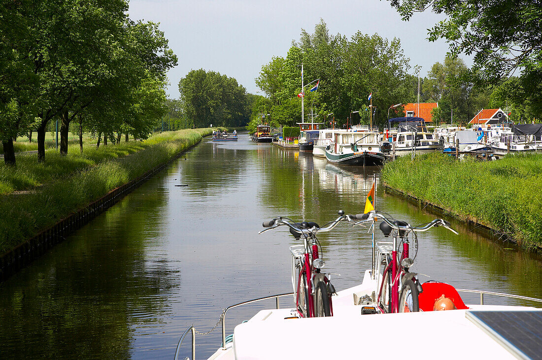 Ein Mann und zwei Fahrräder auf einem Hausboot auf dem Fluss Grecht, Holland, Europa