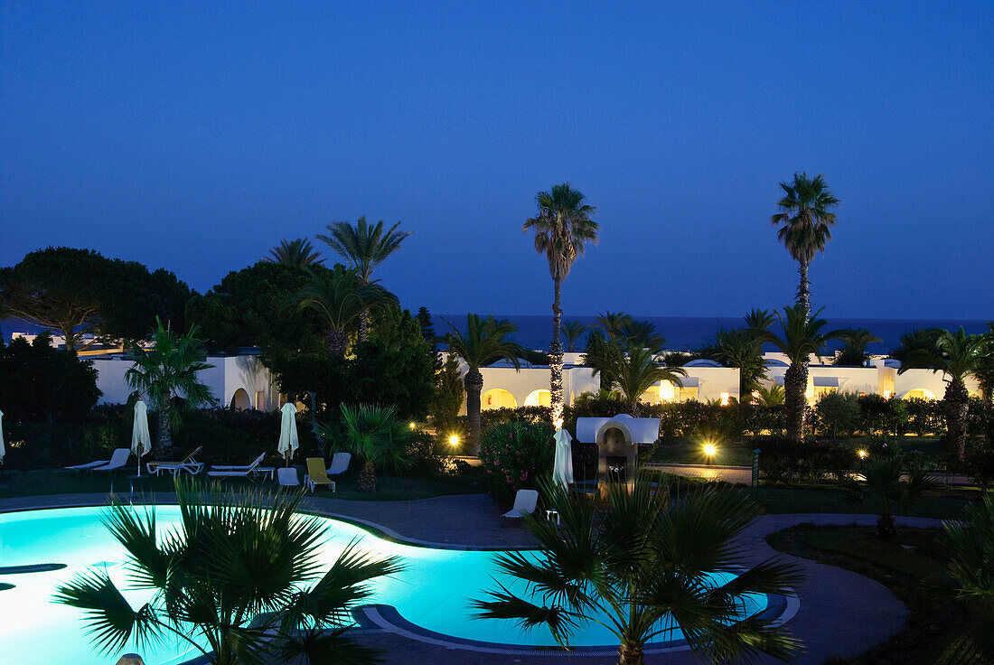 An illuminated pool and palm trees at night, Hammamet, Gouvernorat Nabeul, Tunisia, Africa