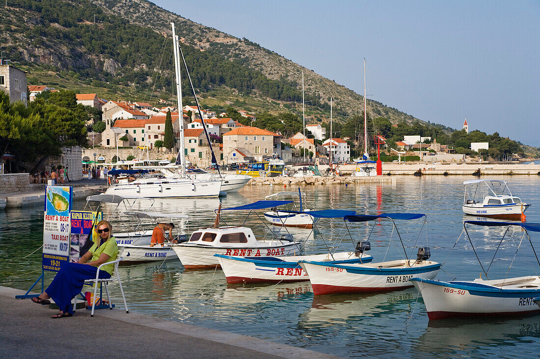 Boats are moored at Bol harbour in the sunlight, Brac Island, Dalmatia, Croatia, Europe