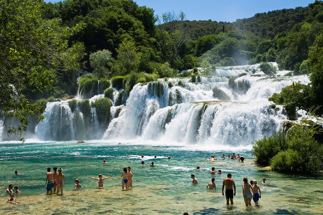 People bathing in the river at Krka waterfalls, Krka National Park, Dalmatia, Croatia, Europe