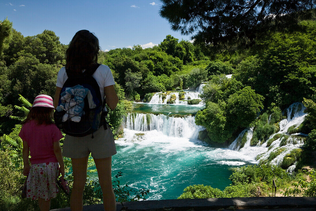 A woman and a child looking at the Krka waterfalls, Krka National Park, Dalmatia, Croatia, Europe