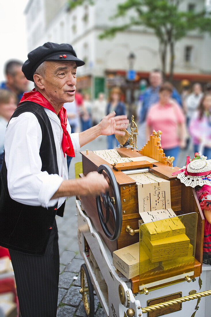 Street musician playing organ and singing in Montmartre, Paris