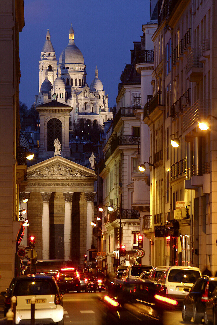 The night view of Sacre-Coeur Church from a street. Paris. France