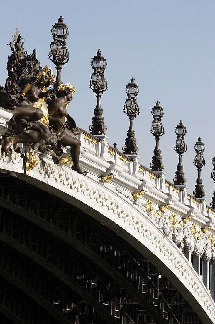 Sculptures and ornate lamp posts decorating Pont Alexandre III. Paris. France
