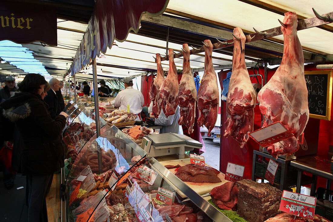 A meat stall in weekend food market. Paris. France