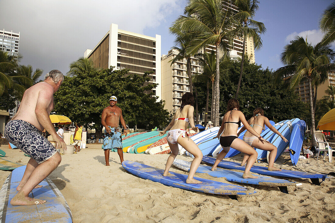 Students of a surfing school practices their skill on Waikiki Beach. Oahu Island. Hawaii. USA