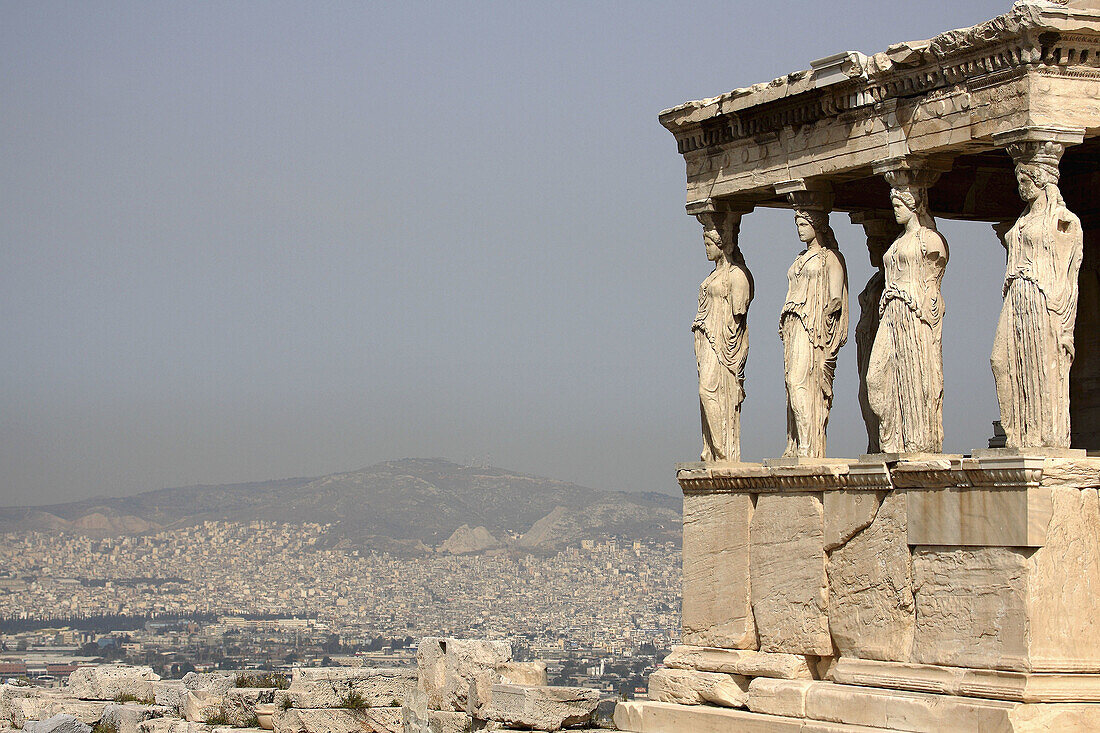 The Porch of Maidens of Erechtheion with the view of city of Athens in the background. Acropolis. Athens. Greece