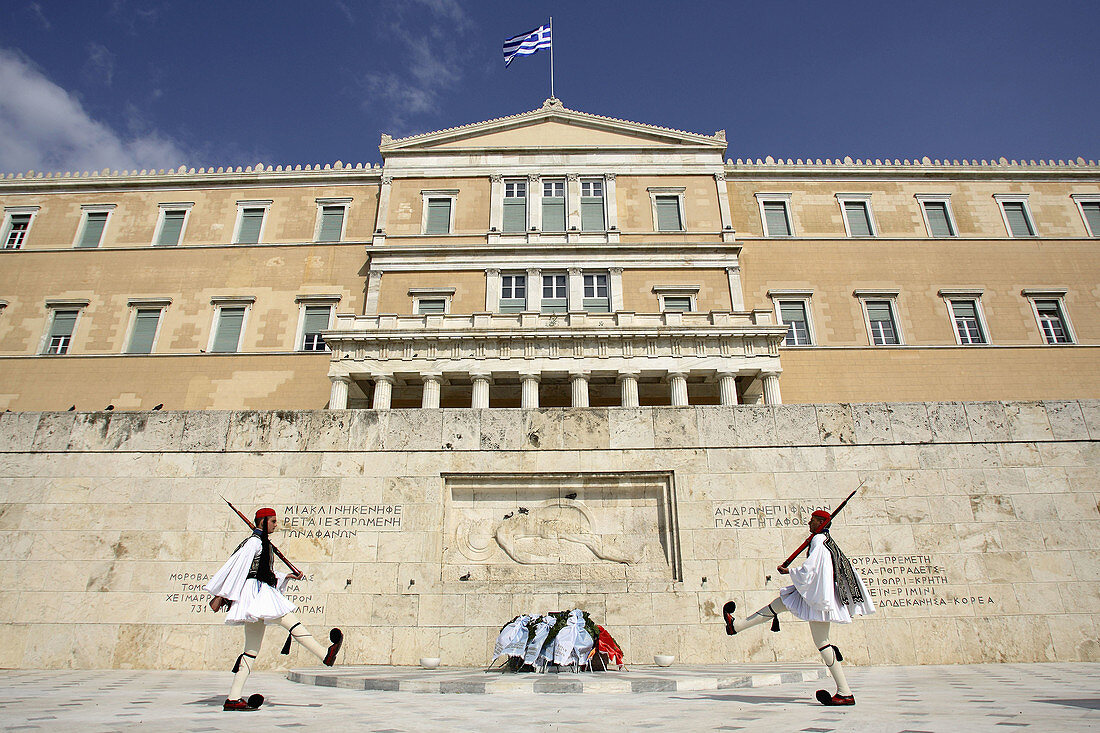The changing of the guard ceremony in front of the Tomb of the unknow soldier with the Parliament Building in the background. Athens. Greece