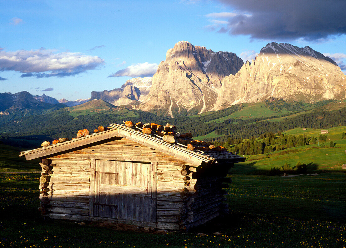 Alpine hut and mountains in the light of the evening sun, Alpe di Siusi, Dolomites, South Tyrol, Italy, Europe
