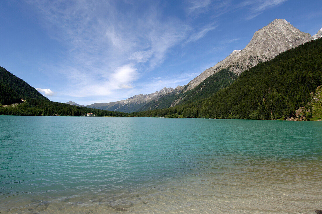 View at Antholzer lake between mountains under blue sky, Val Pusteria, South Tyrol, Italy, Europe