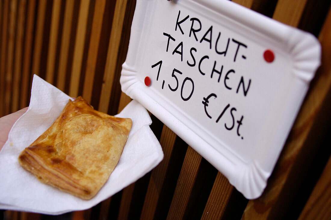 Filled pastry and a sign at christmas market, Glurns, Val Venosta, South Tyrol, Italy, Europe