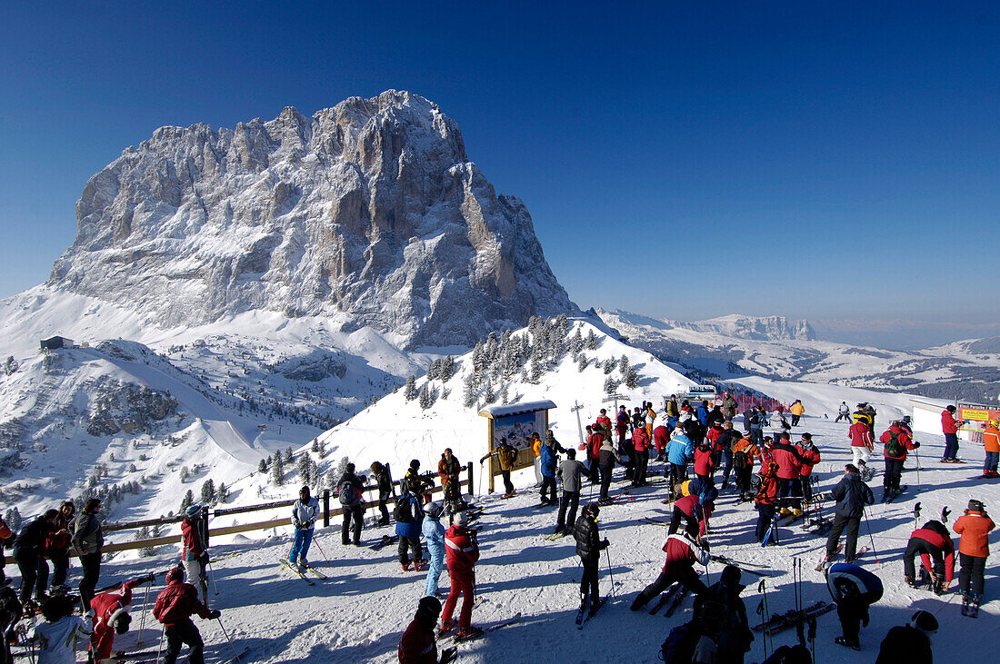 Skiers on a ski slope near the summit station, Mountain landscape in Winter, Sella Ronda, Gherdeina, Val Gardena, South Tyrol, Italy