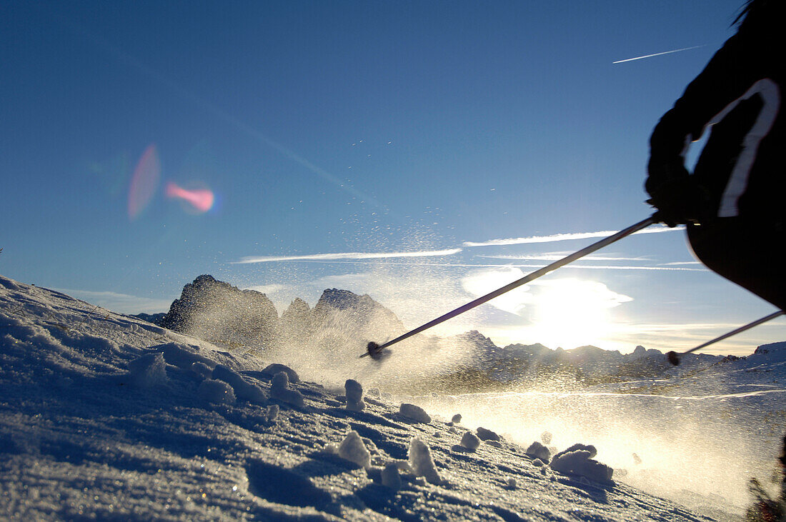 Female Skier skiing down a slope, Mountain landscape, Seiser Alm, Langkofel mountain range, South Tyrol, Italy