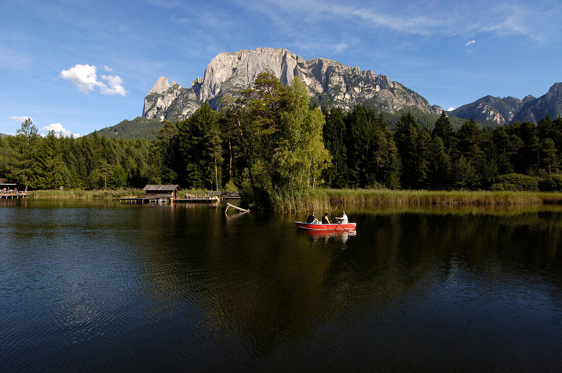 Lake with rowing boat, Voelser Weiher, Voels am Schlern, South Tyrol, Italy
