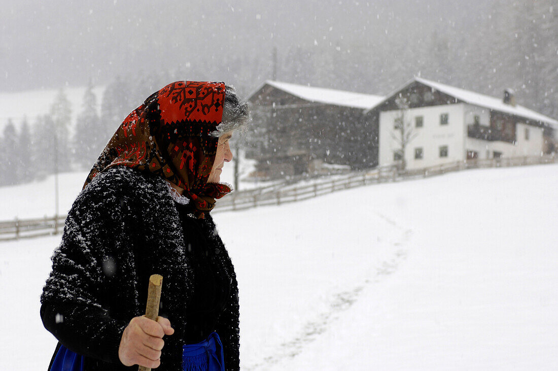 Female farmer walking through the snow, Farmhouse, Agriculture, South Tyrol, Italy