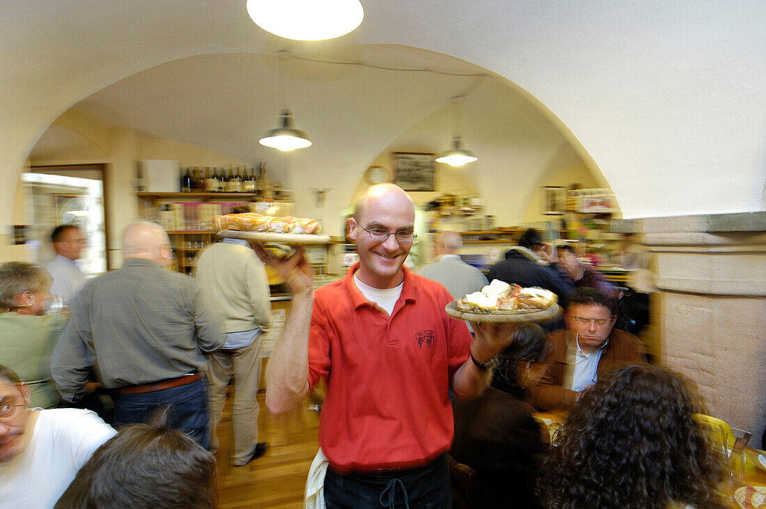 Waiter and restaurant guests Osteria Dai Carrettai, Bolzano, South Tyrol, Italy