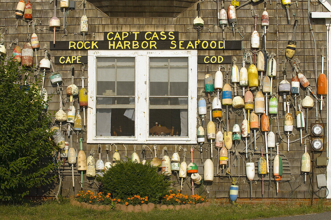 A display of buoys on the outside of Captain Cass' Rock Harbor Seafood Restaurant, Rock Harbor, Orleans, Cape Cod, Massachusetts, USA