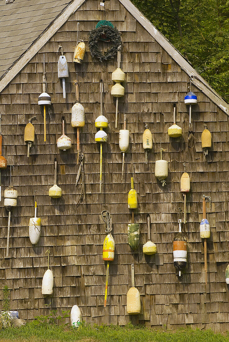 Wall of buoys on the side of a cottage in Orleans, Cape Cod, Massachusetts, USA
