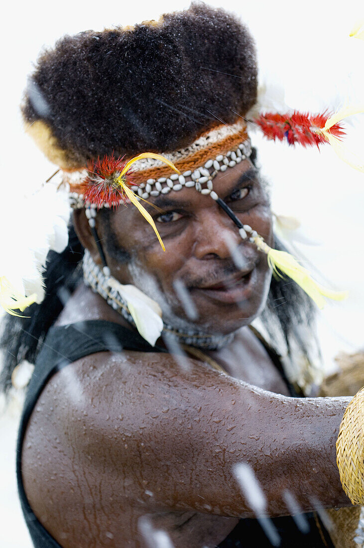 Papuan tribesman wearing traditional hat made of cuscus fur, Indonesia
